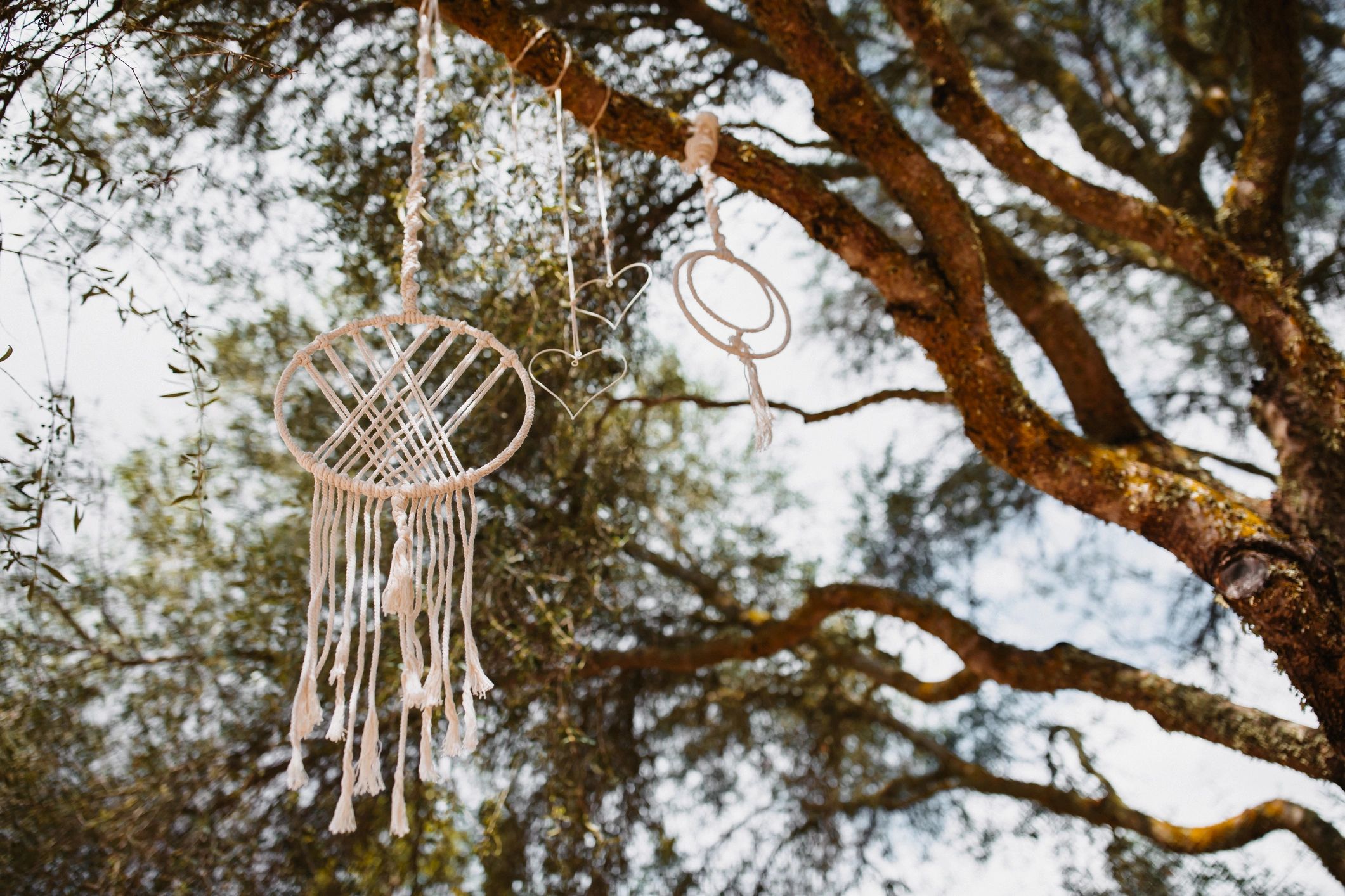 Homemade macrame dreamcatcher and metal hearts hanging on